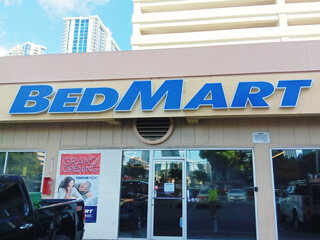 Illuminated channel letter business sign for BedMart at Ala Moana Shopping Center in Honolulu Hawaii made by Sign Builders HI
